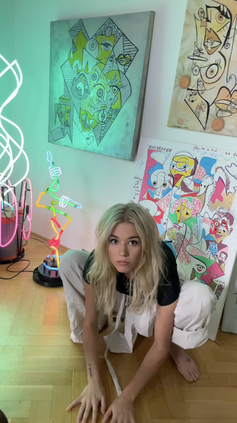 Aneta Kernová in her studio with neon sculptures